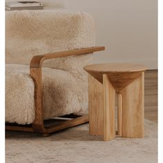 a chair and table sitting on top of a rug