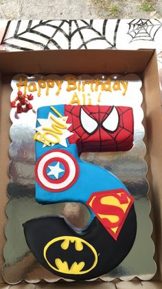 a birthday cake in the shape of a number 5 with a spiderman and batman symbol