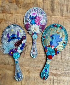 two colorful hairbrushes sitting on top of a wooden table next to each other