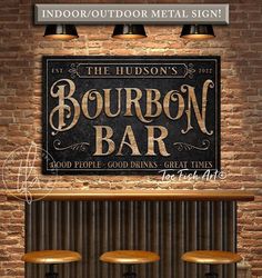 the bourbon bar sign is hanging on the brick wall in front of three stools