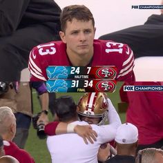 a football player is being hugged by an official