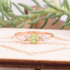 "Simple & dainty 14k rose gold peridot promise ring for her, Elegant 3 stone womens promise ring, Gold 3 stone peridot engagement ring WE OFFER UNLIMITED PERIOD INSTALLMENTS PLAN This is a beautiful, stunning, feminine ring that works well for all occasions, styles, and ages. You will love it! Ring information Main stone: Peridot Approximate size: 4.5mm Accent stone: Cubic zirconia Approximate size: 3mm Metal type: Gold Metal stamp: 14k solid gold Customization / Replacements It's easy to cr Fine Jewelry In Rose Gold With Three Stones, Rose Gold Three Stone Fine Jewelry, Fine Rose Gold Three Stone Jewelry, Three Stone Peridot Jewelry As Gift, Three-stone Fine Jewelry For Proposal, Dainty Three Stone Cubic Zirconia Jewelry, Three Stone Round Jewelry For Proposal, Peridot Three Stone Jewelry As Gift, Round Three Stone Jewelry For Proposal