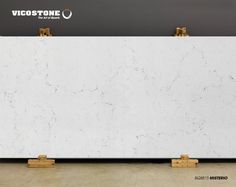 a white marble counter top with two golden handles on each side and the words viccostone above it