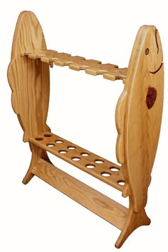 a wooden rack with two paddles attached to it and a smiling face drawn on the side