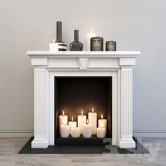 a white fireplace with lit candles in it