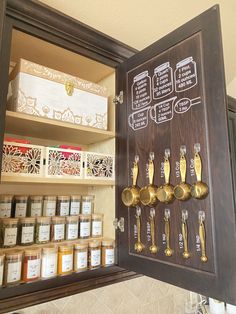 an open cabinet filled with lots of jars and spoons next to shelves full of spices