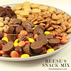 a white plate topped with lots of different types of nuts and chocolates on top of each other