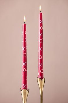 two red candles sitting next to each other