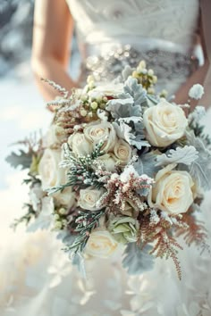 a bridal holding a bouquet of white roses