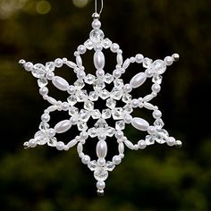 a snowflake ornament hanging from a tree