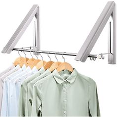 the clothes hanger is holding four shirts and two pants on it's hooks