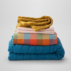 folded blankets stacked on top of each other