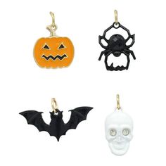 four halloween charms in different colors and shapes with bats, skulls, and pumpkins