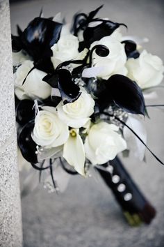 a bridal bouquet with white and black flowers