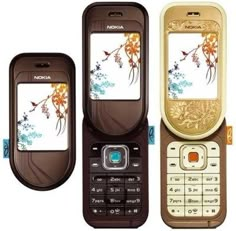 three cell phones sitting next to each other on top of a white surface with flowers painted on them