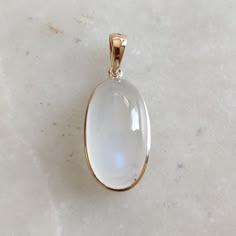 This stunning pendant is set in 14k Solid Yellow Gold with Natural Rainbow Moonstone with utmost precision. It is a unique gemstone pendant for nearly every occasion and is completely hassle-free jewelry. ITEM DETAILS: * GEM: Rainbow Moonstone * GEM Size: 11X18mm * GEM Shape: Oval * Gem Weight: 12.86 carats * Gold Purity: 14KT  * Gold Weight: 0.62 gram * Total Weight of the Pendant: 3.19 gram The Gold purity is guaranteed and it comes with an authentic 14KT gold hallmark. Since my items are handmade, they are absolutely nickel and lead free. CUSTOMIZATION: * Gemstone customization is available and it can be substituted with a gem of your choice. Kindly message me for the same. PACKAGING * The Pendant comes with layers of safe and secure wrapping along with a Free handmade jewelry box with Afro Jewelry, Ethereal Jewelry, Rainbow Moonstone Necklace, Handmade Jewelry Box, Gemstone Pendant Necklace, Gem Necklace, Blue Moonstone, Bezel Pendant, Jewelry Christmas