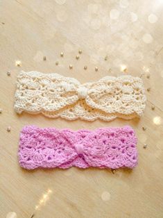 two crocheted headbands laying on top of a wooden floor