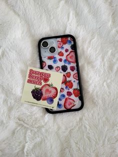 an iphone case with strawberries and berries on it next to a sticker that says happy valentine's day