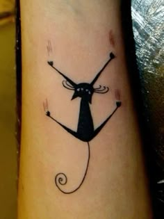 a black cat tattoo on the arm