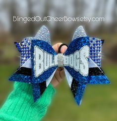 follow us on tiktok @blingedoutcheerbows to see brand new bow styles first! Price per bow is $25   These bows are not discounted further for team orders  rhinestone cheer bow// Royal blue Rhinestone cheer bow//competition cheer bow//bling bow//team colors//customizable bows// Royal blue , white and black cheer bow team name cheer bow I've made triple threat bows for local, state, regional and national championships.  Please allow 4 weeks for customization. like us on facebook "blinged out cheer bows"