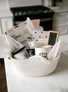 a white basket filled with lots of items on top of a counter