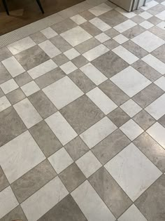 a white and grey checkered tile floor in a kitchen