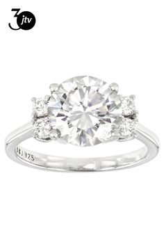 an engagement ring with three stones on the side and two diamonds in the middle,