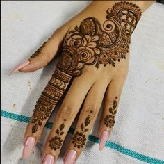 a woman's hand with henna tattoos on it