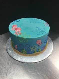 there is a blue cake decorated with sea animals