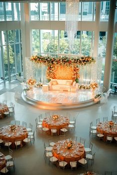 Elegant wedding bar setup with a luxurious floral chandelier hanging above, featuring rich autumn colors in orange, burgundy, and yellow, set against a modern city venue. Wedding Bar Setup, Bar Setup, Ghost Chairs, Floral Chandelier, Bar Set Up, Wedding Bar