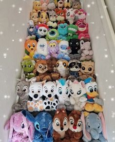 there are many stuffed animals lined up on the stairs