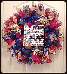 a red, white and blue wreath with words on it