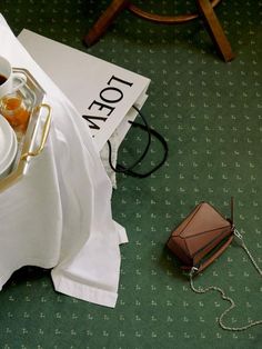 a tea set on a table next to a bag and some papers with the word top ten written on it