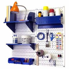 the pegboard is organized with craft supplies and tools to make it look like shelving