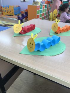 the very hungry caterpillars are made out of construction paper on the table