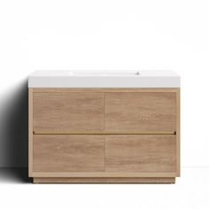 a white sink sitting on top of a wooden cabinet