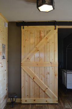 an open sliding door in a room with wood floors and walls, along with a bench