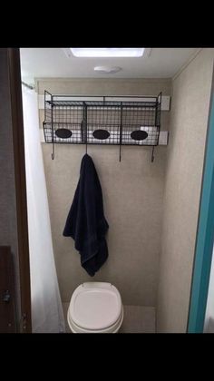 a small bathroom with a toilet and towel rack