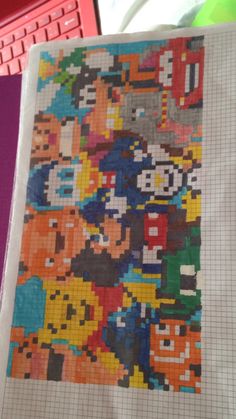 a piece of art made out of legos and video game characters on a sheet of paper