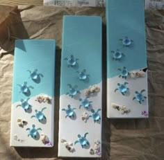 three blue and white boxes with sea shells on them