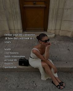 a woman sitting on steps talking on her cell phone