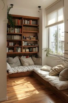 a living room filled with lots of furniture and bookshelves next to a window