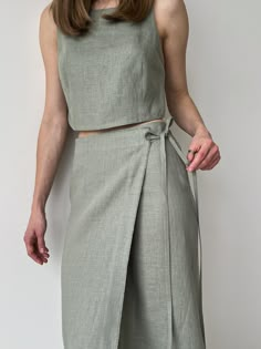 Linen wrap skirt for women and linen crop top, Green linen skirt and linen top, Wrapped skirt, Linen womens suit Linen makes the best micro-climate of the skin, is breathable, and absorbs moisture and perspiration. ■ color: green ■ material: 100% linen ■ style: - wrap skirt - relaxed fit - mid-calf length - high waist - textile belt -raw edge ■ fit: The model is 168cm/ 5′ 6″ tall and wears a size XS ■ how to care: - Hand wash or gentle machine wash cycle 40oC / cold water - Hang to dry for best results. Avoid tumble drying to prevent color fading - Don't bleach - We do not suggest you iron your linen garment to have a soft relaxed look. But if you wish to, we recommend ironing it inside out and setting medium heat on the iron. Garments may also be steamed in a moderate setting. ■ the color Casual Summer Wrap Skirt, Wrap Skirt Corset, Luxury Linen Skirt For Work, Luxury Relaxed Fit Skirt For Summer, Luxury Linen Midi Skirt, Chic Luxury Wrap Skirt, Luxury Fitted Linen Skirt, Luxury Summer Draped Skirt For Women, Sewing Wrap Around Skirt