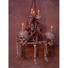 a skeleton chandelier with candles in it