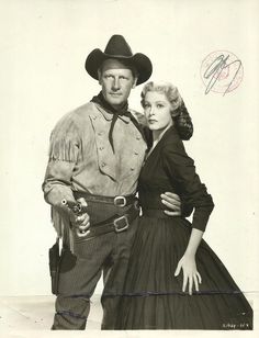 a man and woman dressed in western clothing