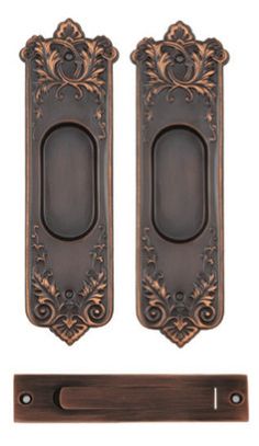 two ornate door handles and a handle for the front or back of an open door