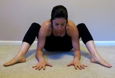 a woman is sitting on the floor with her legs spread out in front of her