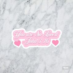 you are so loved sticker in pink on marble background with text that reads, you are so loved john 3 16