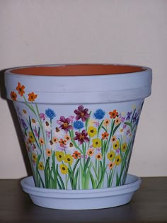 a flower pot with flowers painted on it