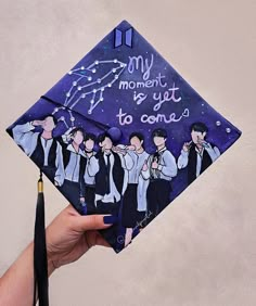 a hand holding up a graduation cap with the words, my moment is yet to come